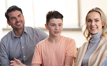 child and parents talking to counselor
