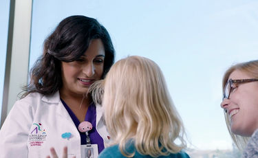 Female doctor with patient and friend